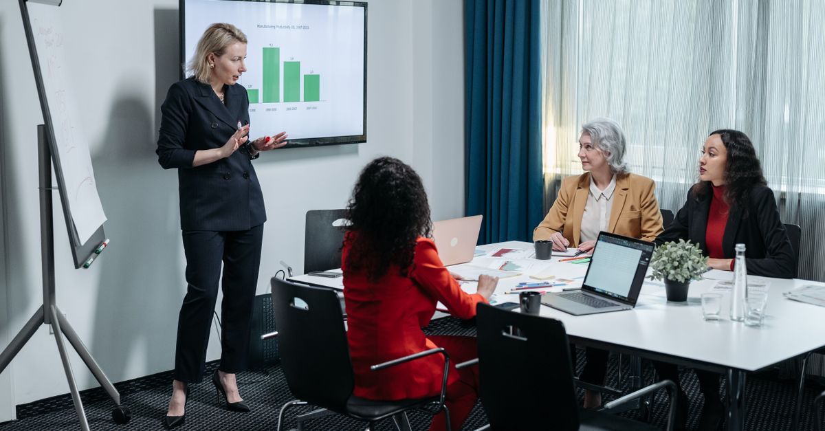 Team presenting work in an office meeting.